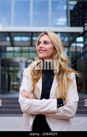 Femme d'affaires adulte caucasienne élégante moderne habillée en costume formel debout dans le lieu de travail à l'extérieur Banque D'Images