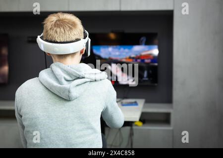 Osnabrück, Deutschland 29. Avril 2024 Im Bild : Ein Jugendlicher sitzt mit einer Virtual Reality brille, VR brille, vor einem Fernseher und spielt, zockt, ein Konsolenspiel auf einer Konsole. B ZEHN Niedersachsen *** Osnabrück, Allemagne 29 avril 2024 dans l'image Un jeune est assis devant une télévision avec des lunettes de réalité virtuelle, des lunettes VR, et joue, joue, un jeu de console sur une console B ZEHN Niedersachsen Copyright : xFotostandx/xGelhotx Banque D'Images