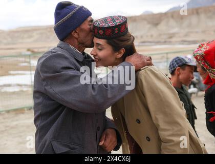 (240502) -- URUMQI, 2 mai 2024 (Xinhua) -- Airkir Duliki rencontre son grand-père (l) au comté autonome tadjik de Taxkorgan, dans la région autonome ouïgur du Xinjiang, au nord-ouest de la Chine, le 22 mars 2024. Airkir Duliki, le chef de train tadjik âgé de 27 ans, est né et a grandi au milieu des montagnes enneigées et des prairies dans un village du comté autonome tadjik de Taxkorgan sur le plateau du Pamir, où les chemins de fer n'étaient pas courants pour les résidents dans le passé. La première expérience d'Airkir avec le voyage en train s'est produite quand elle s'est rendue à Urumqi pour l'université au Xinjiang. Accompagnée de son père, elle Banque D'Images