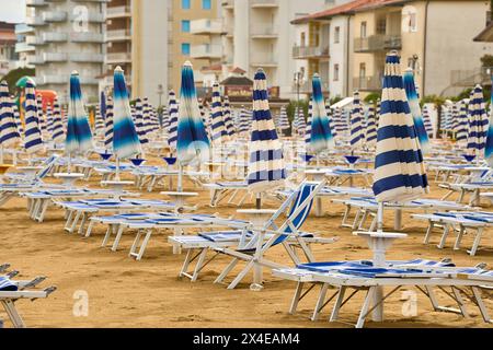 Lido di Jesolo, Italie - 2 mai 2024 : parasols fermés sur la plage de Lido di Jesolo en Italie *** Geschlossene Sonnenschirme am Strand von Lido di Jesolo in Italien Banque D'Images