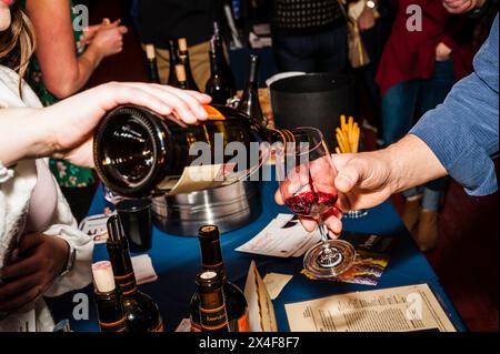 États-Unis, État de Washington, Walla Walla. Femme verse du vin rouge dans un verre lors d'un événement de vin à Walla Walla. (Usage éditorial uniquement) Banque D'Images