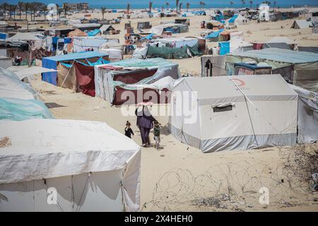 Gaza, Gaza, Palestine. 2 mai 2024. Une palestinienne porte du pain sur la tête au milieu des tentes et va le cuire sur le four en argile pour nourrir ses enfants (crédit image : © Saher Alghorra/ZUMA Press Wire) USAGE ÉDITORIAL SEULEMENT! Non destiné à UN USAGE commercial ! Banque D'Images