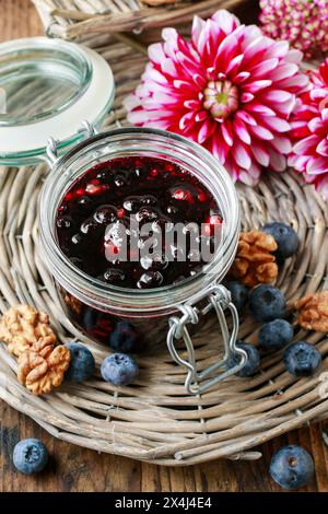 Pot de confiture de myrtilles, miel et fleurs de dahlia. Une alimentation saine Banque D'Images