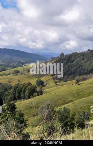 regardant au-dessus d'une vallée verdoyante à des montagnes lointaines Banque D'Images