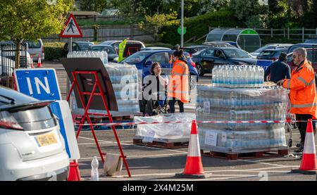 Une dame handicapée (MRS Andrews) recueille les bouteilles d’eau distribuées à l’établissement Lenoards ASDA. Environ 31 000 propriétés à St Leonards et dans certaines parties de Hastings restent sans eau après que Southern Water ait déclaré qu'une rupture de la principale avait perturbé les approvisionnements. On pense qu'il faudra tout le week-end pour réparer le tuyau d'alimentation électrique éclaté. Prog Leonards, East Sussex. Crédit : Reppans/Alamy Live News Banque D'Images