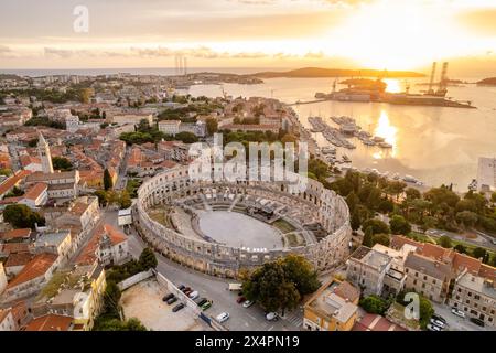 Vue aérienne de l'amphithéâtre romain historique de Pula au coucher du soleil, Croatie Banque D'Images