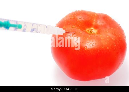 injection dans la tomate, isolée sur blanc Banque D'Images