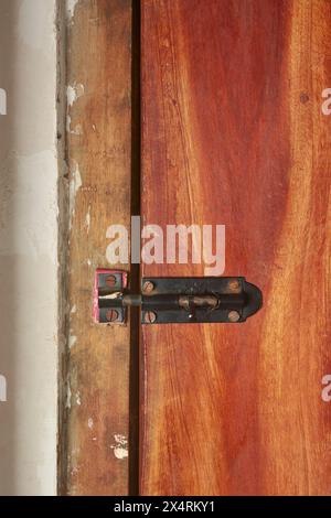 serrure de porte en bois simple ou loquet fixé sur la surface de porte en bois vue rapprochée, orientation verticale avec espace de copie Banque D'Images