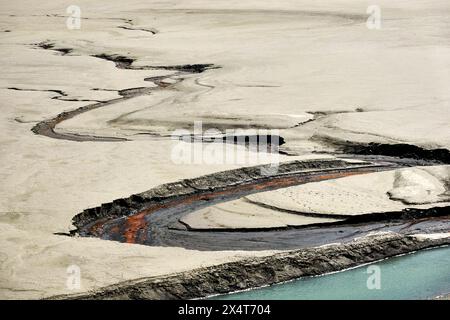 Vue aérienne d'une rivière sinueuse traversant un terrain désertique et sablonneux Banque D'Images