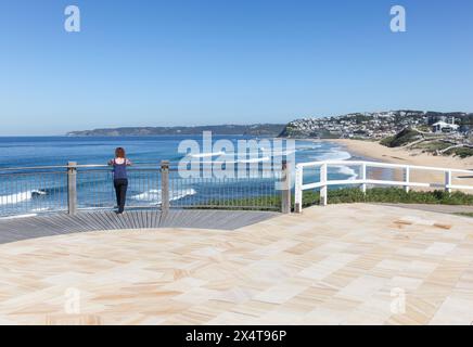 Une femme profite de la vue depuis un belvédère sur Bar Beach et Merewether Beach - Newcastle Australia. Newcastle est une destination populaire avec beaucoup de beautif Banque D'Images