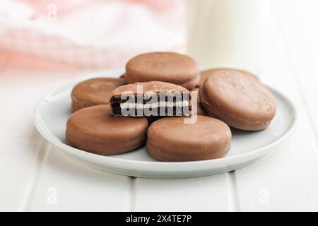 Assiette de biscuits recouverts de chocolat et verre de lait Banque D'Images