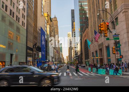 Belle vue sur la 5ème Avenue à Manhattan avec piétons qui flânent, circulation qui coule sur fond de gratte-ciel. New York. Banque D'Images