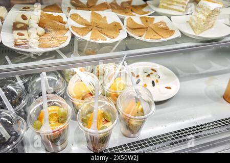 Vitrine présentant une variété de desserts et de coupes de fruits Banque D'Images