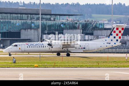 Un Bombardier Dash 8 Q400 de Croatia Airlines se rend en taxi jusqu’au terminal après l’atterrissage à l’aéroport de Zurich. Immatriculation 9A-CQE. (Zurich, Suisse, 10,03 Banque D'Images