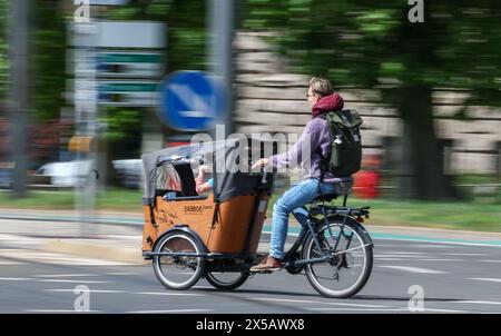 Leipzig, Allemagne. 08 mai 2024. Une femme monte un vélo cargo Babboe Curve à travers le centre-ville. Crédit : Jan Woitas/dpa/Alamy Live News Banque D'Images