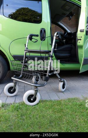 Un déambulateur à roulettes à l'extérieur avec un panier pour l'épicerie et les sacs et la voiture Banque D'Images