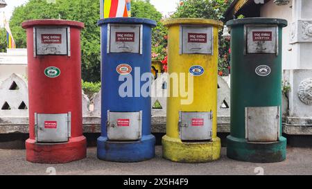 Poubelles colorées à l'extérieur du Temple d'Or, Dambulla, Sri Lanka. Banque D'Images