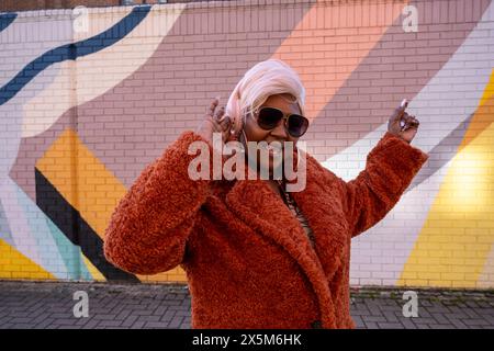 Royaume-Uni, Yorkshire du Sud, Portrait de femme élégante avec écouteurs Banque D'Images