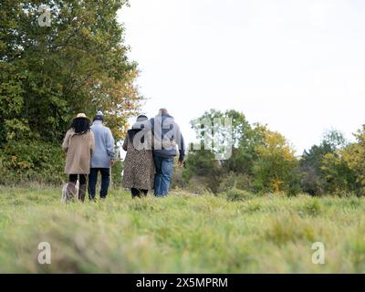 Vue arrière de deux couples seniors marchant ensemble dans la nature Banque D'Images