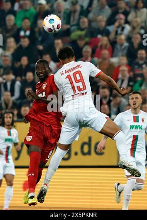 Augsbourg, Allemagne. 10 mai 2024. Felix Uduokhai (top R) d'Augsbourg affronte Serhou Guirassy (top l) de Stuttgart lors du match de première division allemande de Bundesliga entre le FC Augsbourg et le VfB Stuttgart à Augsbourg, en Allemagne, le 10 mai 2024. Crédit : Philippe Ruiz/Xinhua/Alamy Live News Banque D'Images