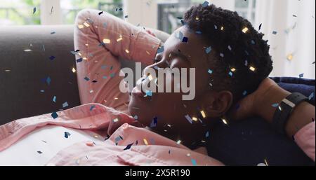 Image de confettis sur une femme afro-américaine qui dort Banque D'Images