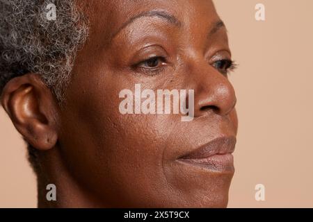 Portrait de femme senior sur fond beige Banque D'Images