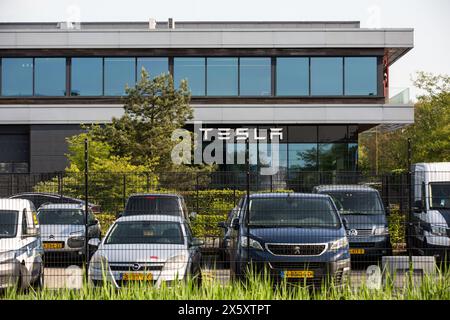 Tilburg, pays-Bas. 1er mai 2024. Une entreprise automobile et énergétique américaine spécialisée dans la fabrication de voitures électriques ; Tesla, enseigne vue sur la façade du bâtiment Tilburg Factory & Delivery Center. Tesla, a plusieurs bâtiments d'usine dans la zone industrielle de Vossenberg à Tilburg. Tilburg Factory & Delivery Center est à côté du canal Wilhelmina permettant la livraison intermodale à base d'eau. (Crédit image : © Karol Serewis/SOPA images via ZUMA Press Wire) USAGE ÉDITORIAL SEULEMENT! Non destiné à UN USAGE commercial ! Banque D'Images