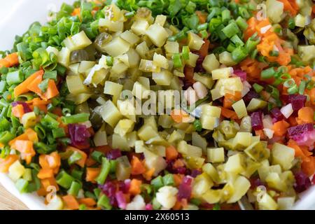 Une salade savoureuse nommée vinaigrette - une salade traditionnelle ukrainienne et russe de légumes. Plat végétarien. Nourriture végétalienne avec oignon vert, pommes de terre bouillies Banque D'Images