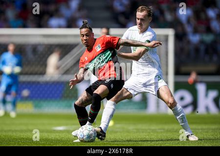 Nimègue, pays-Bas. 12 mai 2024. Nimègue - Tjaronn Chery de NEC Nimègue, Thomas Beelen de Feyenoord lors du match Eredivisie entre NEC contre Feyenoord au Goffertstadion le 12 mai 2024 à Nimègue, pays-Bas. Crédit : Box to Box Pictures/Alamy Live News Banque D'Images