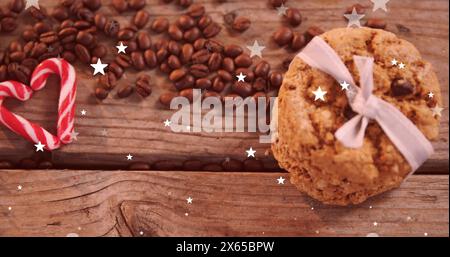 Image d'étoiles tombantes sur des biscuits et des grains de café Banque D'Images