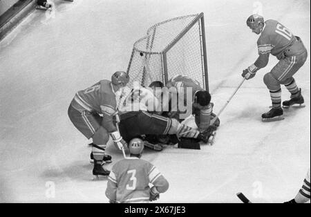 Vintage Jeux Olympiques d'hiver photo : Grenoble 68, compétition de hockey sur glace. URSS v Suède 3-2. Le gardien de but soviétique Victor Zinger arrête la rondelle dans le pli, pendant l'action du match. Banque D'Images