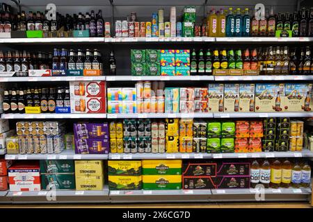 Rangées de bouteilles en plastique boissons alcoolisées diverses variétés de marques de bière artisanale sur les étagères de supermarché à vendre dans Co Op supermarché UK 2024 KATHY DEWITT Banque D'Images