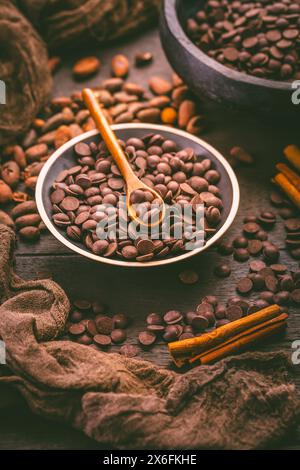 Gouttes de chocolat noir doux-amer avec fèves de cacao, couverture sans sucre, ingrédient de boulangerie et de cuisson Banque D'Images