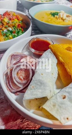 Délicieux wraps kebab de doner de bœuf et d'agneau avec des ingrédients frais, grillés à la perfection sur une assiette blanche. Banque D'Images