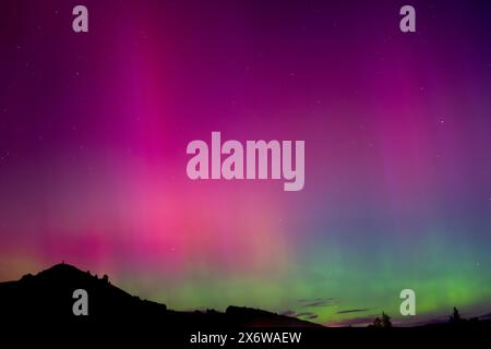 Aurora australis rose et vert sur la montagne Puketapu à Palmerston, Otago. Palmerston est situé dans l'île du Sud de la Nouvelle-Zélande, où le sud Banque D'Images