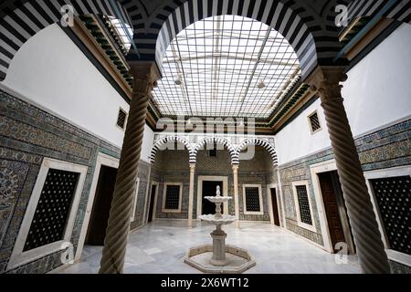 Patio orné avec fontaine et colonnes torsadées au Musée du Bardo Banque D'Images