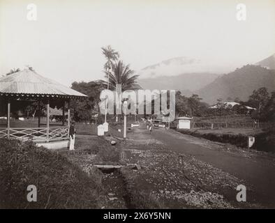 Vue sur la rue à Padang Pandjang avec vue sur le volcan Marapi, vue sur la rue à Pandjang avec un certain nombre de maisons, en arrière-plan le gunung Marapi est visible, photographie, Christiaan Benjamin Nieuwenhuis, (attribué à), Padang Pandjang, 1899 - 1912, papier, impression albumine, hauteur, 212 mm × largeur, 275 mm Banque D'Images