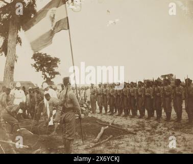 Funérailles militaires avec garde d'honneur africaine, drapeau et (vraisemblablement) Allemands au Cameroun, partie de l'album photo avec enregistrements du Cameroun vers 1899., photographie, anonyme, Kameroen, 1899, support photographique, hauteur, 147 mm × largeur, 186 mm Banque D'Images