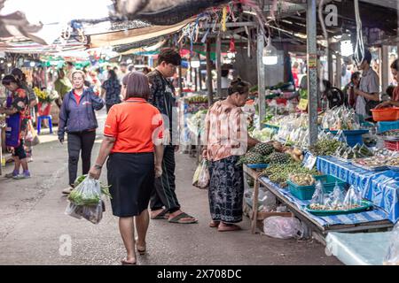 Suratthani, Thaïlande- 24 avril 2024 : les gens marchent dans les rues pour acheter de la nourriture et des fruits, légumes, qui est vendu le long de la route à la fois dans le cit Banque D'Images