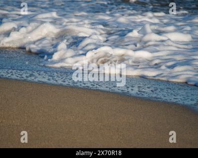 De belles vagues d'eau courbes sont utilisées comme image de fond. Vague océanique. Spectaculaire photo de fond aérienne supérieure de la vague blanche de l'eau de mer de l'océan spla Banque D'Images