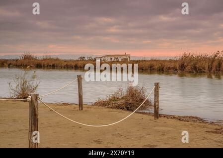 Lever de soleil sur la plage de Platja de Migjorn un matin avec des nuages dans le delta de l'Èbre (Montsià, Tarragone, Catalogne, Espagne) Banque D'Images