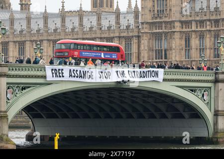Londres, Royaume-Uni. 18 mai 2024. Les partisans de Julian Assange lâchent une bannière disant "Libérez Assange arrêtez l'extradition" sur le pont de Westminster avant l'audience d'appel de l'extradition du fondateur de Wikileaks à la haute Cour la semaine prochaine. M. Assange risque d'être extradé vers les États-Unis pour faire face à des accusations d'espionnage suite à la publication de documents, dont certains dont les partisans affirment qu'ils contenaient des preuves de crimes de guerre américains en Afghanistan et en Irak. Crédit : Ron Fassbender/Alamy Live News Banque D'Images