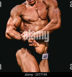 l'athlète bodybuilder montre une posture de poitrine latérale pour la compétition de musculation Banque D'Images
