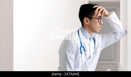 Médecin asiatique masculin déprimé en clinique. Bannière pour la conception Banque D'Images