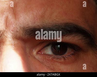 Gros plan d'un homme à la peau foncée avec de larges sourcils épais et de longs cils. APPAREIL PHOTO NUMÉRIQUE OLYMPUS Banque D'Images