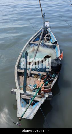 bateau de pêche en bois avec filet penché sur la plage le matin Banque D'Images