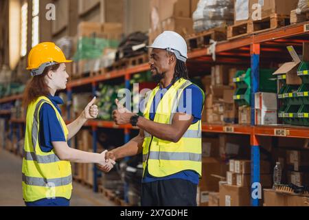 Travailleur dans l'entrepôt de cargaison travail d'équipe soutenir les jeunes femmes stagiaires avec contremaître africain aide ensemble Banque D'Images