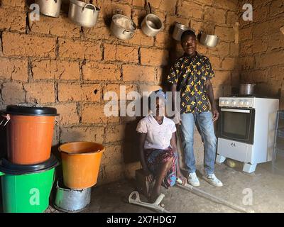 Calulo, Angola. 03 mai 2024. Ana José Capagaio (37 ans), petite agricultrice, se tient avec son frère Joao Capagaio dans leur maison dans le village de Calulo, dans la province angolaise de Kwanza Sul. La mère célibataire de sept enfants a marché sur une mine terrestre en cherchant du bois de chauffage et a perdu sa jambe gauche. Désamorcer les mines terrestres est une tâche laborieuse. Maintenant, des rats hamsters géants aident à nettoyer les explosifs. Crédit : Kristin Palitza/dpa/Alamy Live News Banque D'Images