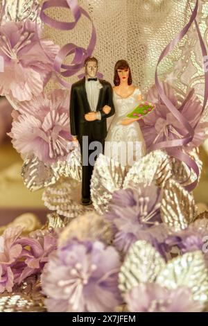 mariée de mariage et marié en haut du gâteau, décorations dentelle et fleurs Banque D'Images