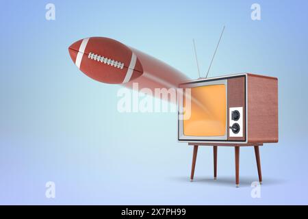 Télévision vintage avec un ballon de football américain Banque D'Images